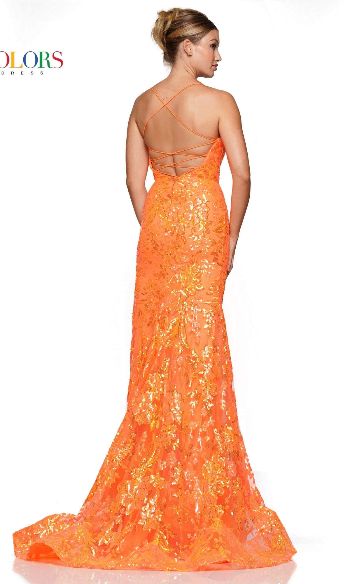 A woman stands facing away from the camera in the Sequin-Embroidered Long Formal Prom Dress 3139, a floor-length bright orange gown featuring sequins and a lace-up open back.